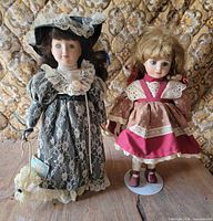 Both porcelain dolls standing on table