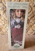 Front view of boxed Seymour Mann Connoisseur Collection porcelain doll
