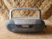 Front view of Sony boombox showing speakers, controls, display