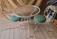 Full view of glass-top table with two chairs