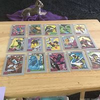 All fifteen cards laid out in three rows of five on a table