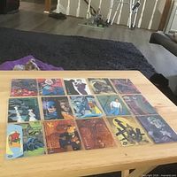 Overview of 16 Batman trading cards arranged in 4×4 grid on table