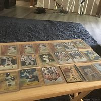 Wide view of all 18 baseball cards laid out on table