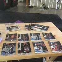 Overview of table showing stacks and spread of basketball cards and plastic case