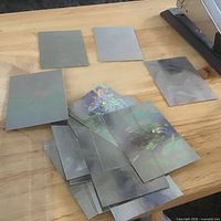Stack and spread of reflective hologram cards on table