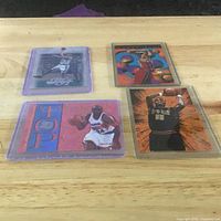 Group shot of all four sleeved basketball cards on a table