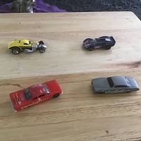 overview of four die-cast cars on table
