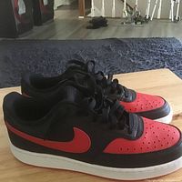 Side view of both sneakers showing black/red upper and white midsole