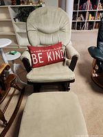 Front view of beige microfiber glider chair with matching ottoman