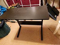 Full view of black desk showing top and frame