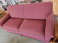 Full view of burgundy jacquard loveseat with two seat cushions