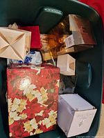 Contents inside large green tub including ornaments, gift and storage boxes