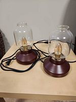 Pair of IKEA table lamps showing bases, shades, cords, and bulbs