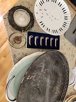 Group view showing all items: silver tray, turkey platter, piano plate, swan rests in box, brass chafing stand components