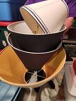 Nested stack of three lampshades showing colors and shapes