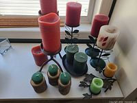 Overall view of candles and holders on shelf
