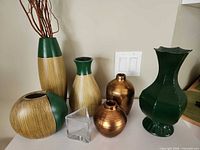 Group shot of all seven vases on table