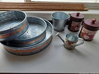 All items grouped: three trays, pail, watering can, two canisters