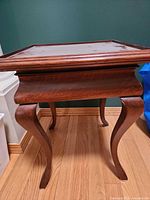 Side view showing full table and cabriole legs