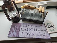 Group image of all items: lantern, crate with jars, corkscrew, two signs