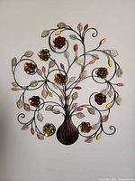 Full view of metal floral vase wall art on wall
