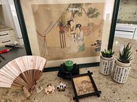 Group shot showing framed print, fan, figurines, succulent pots, tile and candle holder
