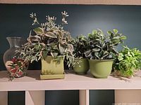 Overall group of vase and four planters with faux plants