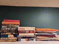 Front view of all stacked books showing variety and spines