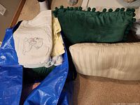 Lot overview showing pillows and blankets inside blue bag