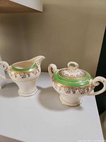 Overall view of Myott Royalty creamer and lidded sugar bowl