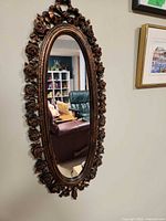Full view of oval mirror on wall