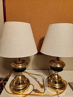 Front view of both brass table lamps with shades