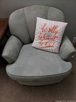 Front view of first armchair with decorative pillow