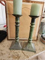 Front view of both candlesticks standing side by side showing color, form and similar height