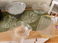 Group shot of all six pressed glass pieces on table