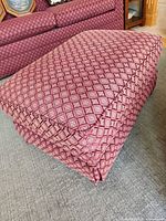 Full view of ottoman showing upholstery pattern and form