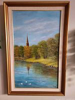 Full view of framed vertical landscape painting
