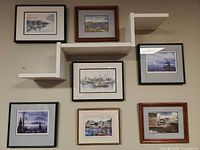 Overall view of seven framed prints arranged on wall