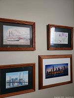 All four framed prints hung together showing subjects and frames