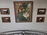 All five framed prints displayed on wall