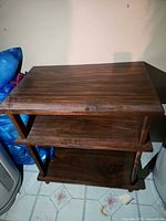 Front view of dark brown 3-shelf bookcase showing overall structure and finish
