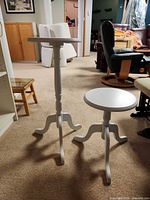 Both pedestal tables standing side by side showing relative heights and design
