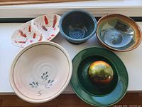 Group shot of all five stoneware bowls showing shapes and glaze colors