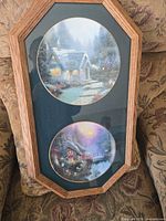 Front view of octagonal frame holding two Thomas Kinkade collector plates