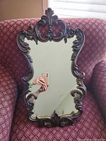 Front view showing full mirror and ornate frame