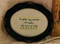 Front view showing stitched quote and frame style