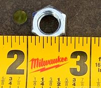 Close-up of a single 3/8" hex bolt beside ruler for scale