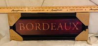 Front view of rectangular Bordeaux sign with ruler for scale