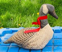 Left side view of goose cushion on blue surface