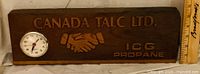 Front view showing carved text, handshake motif and inset clock